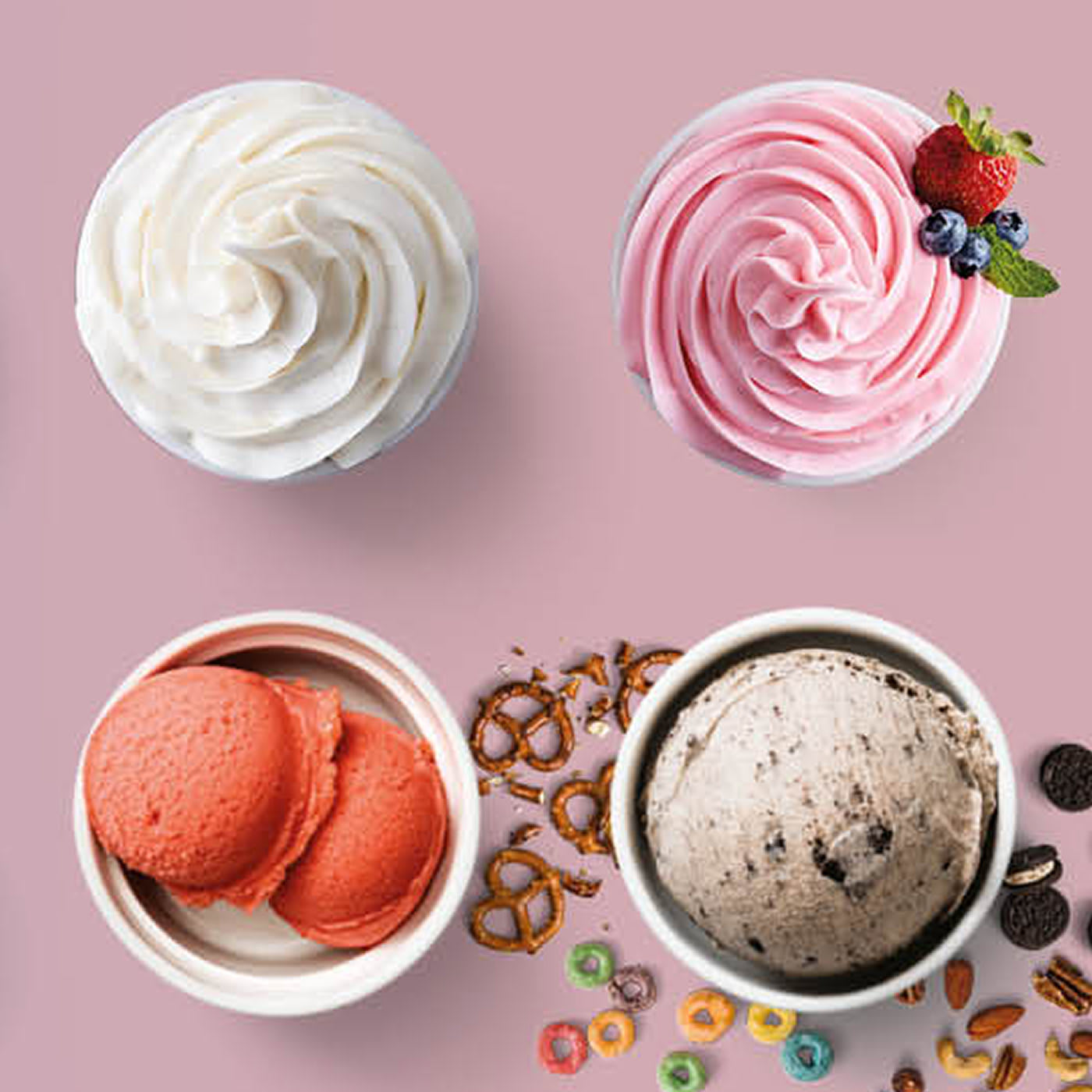 Four different frozen dessert bowls, including whipped cream, pink berry swirl, ice cream with cookies, and red sorbet with pretzels and toppings.