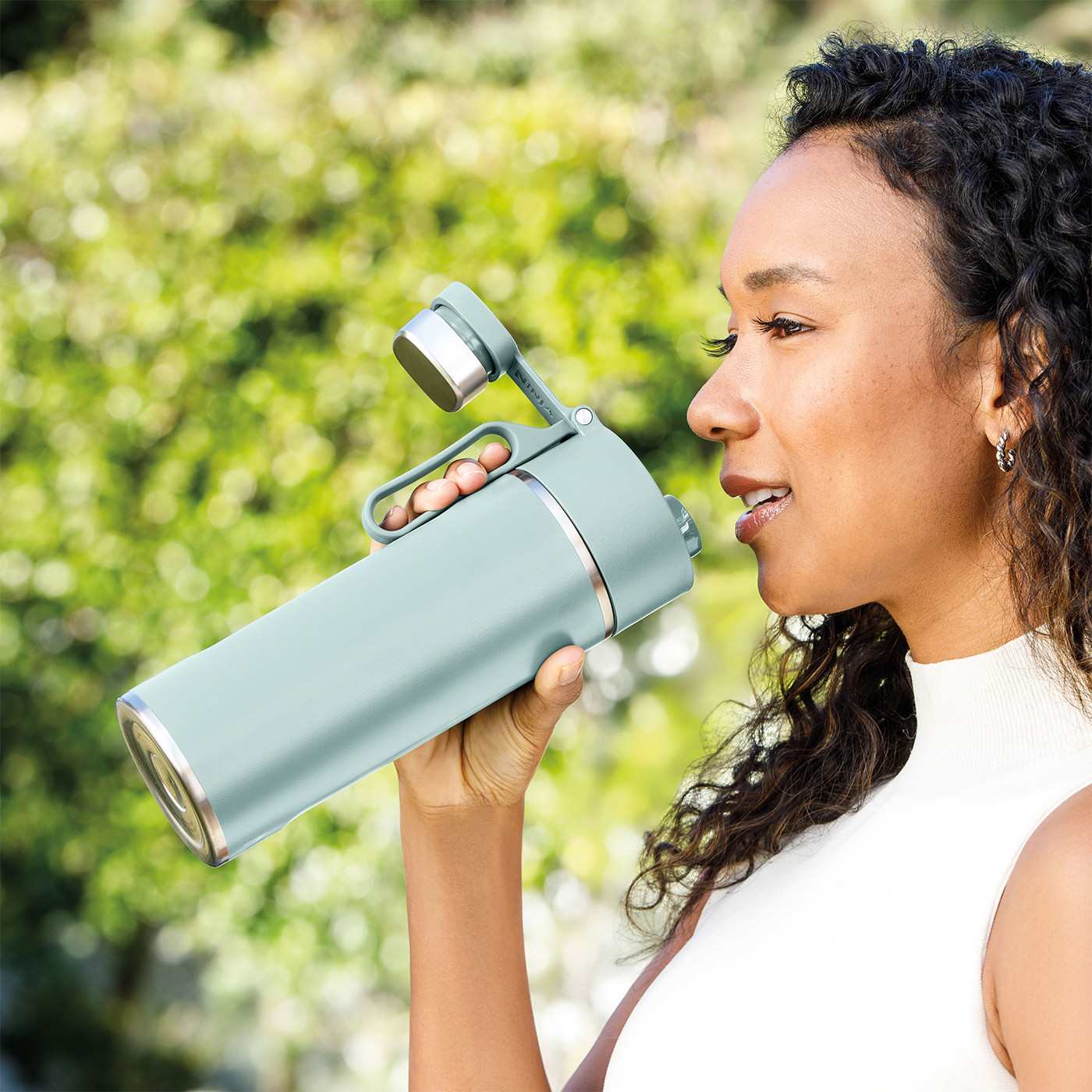 Image of a woman holding the Ninja Mint Thirsti Travel Bottle